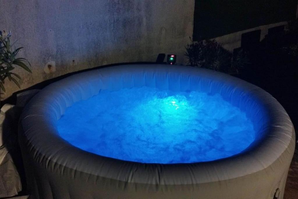 a large blue hot tub in a room at Appartement terrasse et jacuzzi in Aulnay-sous-Bois