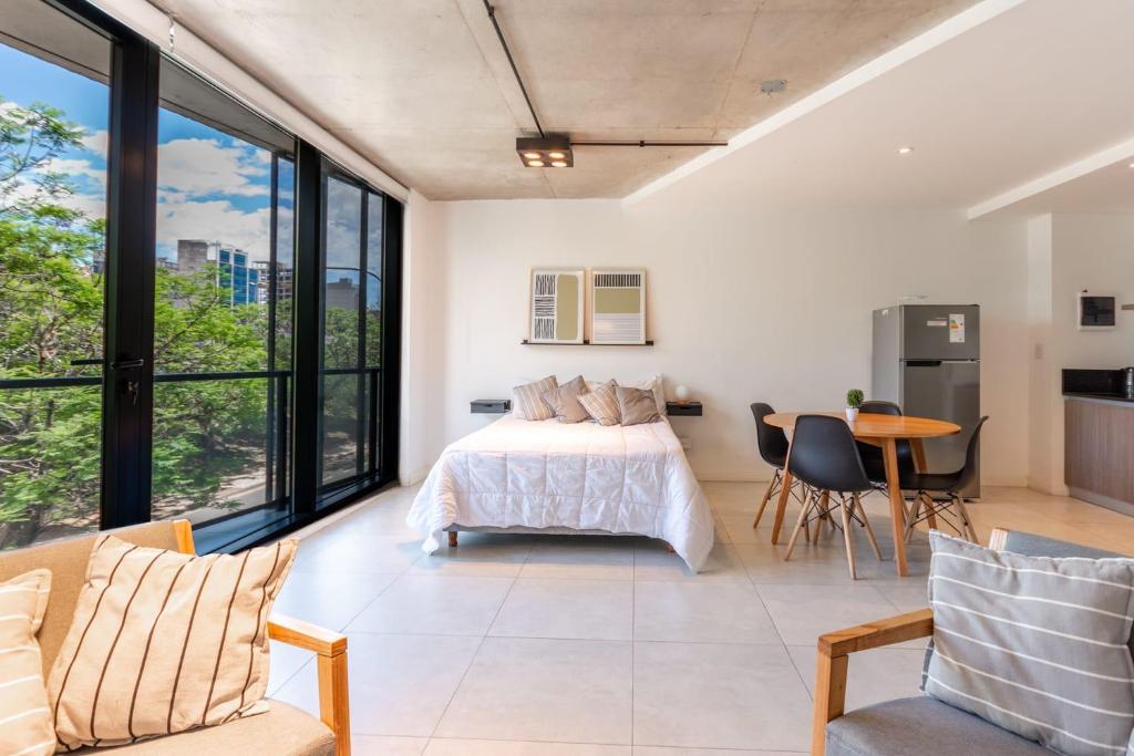 a bedroom with a bed and a table and chairs at NUEVO Loft triple a 5 minutos de Puerto Madero 1A in Buenos Aires