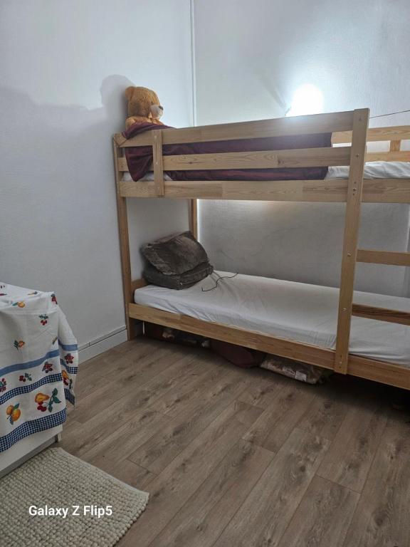 un lit superposé avec un ours en peluche assis dessus dans l'établissement Studio super emplacement, à Boulogne-Billancourt