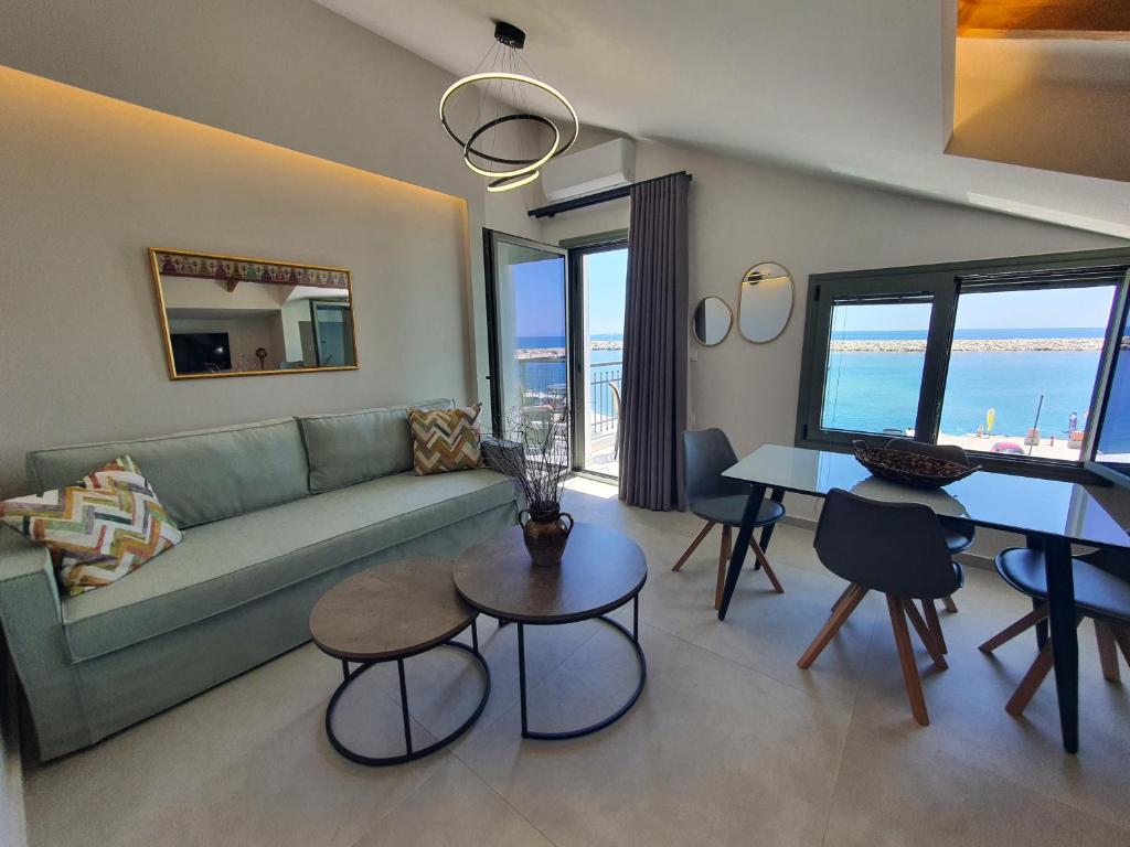 a living room with a couch and a table at Sealon Suite & Loft in Limenaria