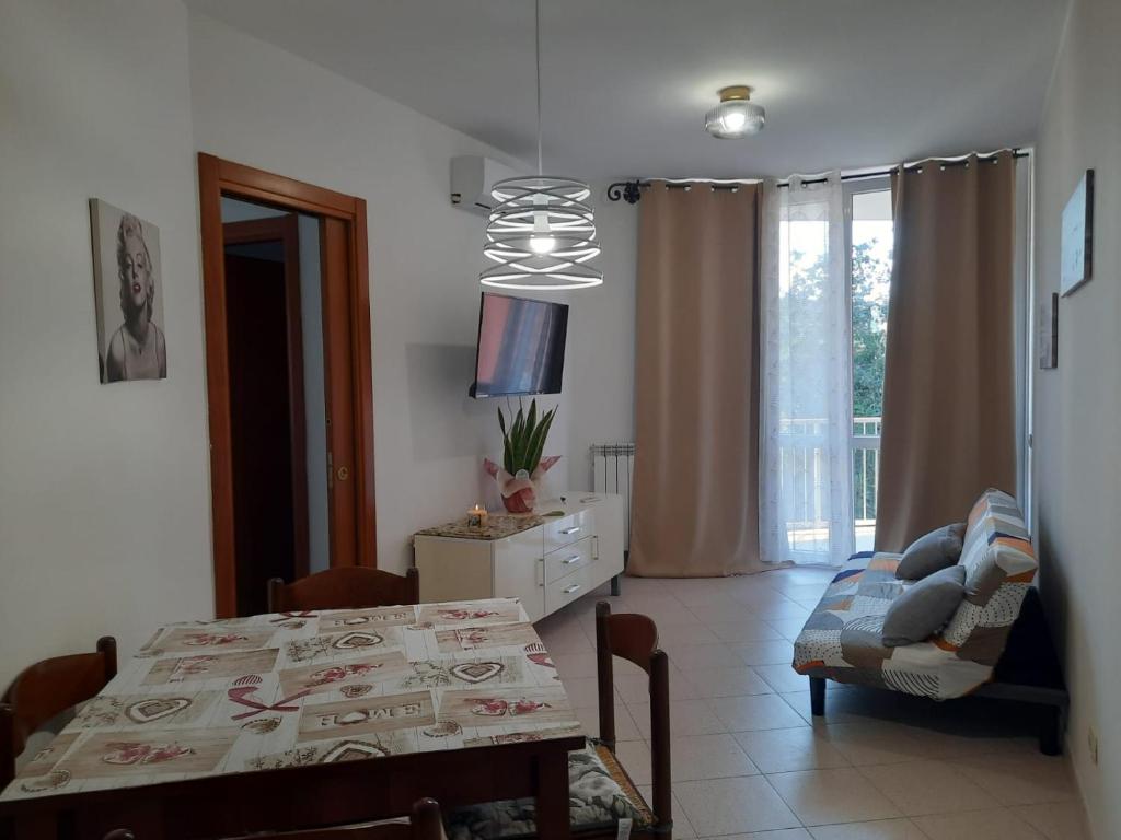 a living room with a table and a dining room at La casa di Federica in Spoleto