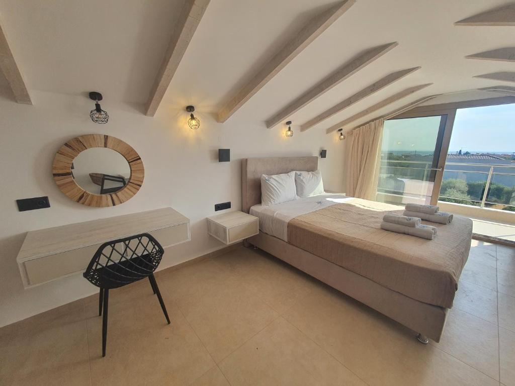 a bedroom with a bed and a mirror and a chair at Calma Living in Potos