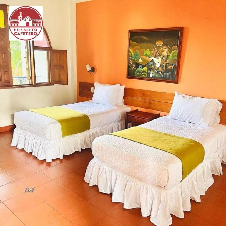 Postel nebo postele na pokoji v ubytování Hotel Pueblito Cafetero