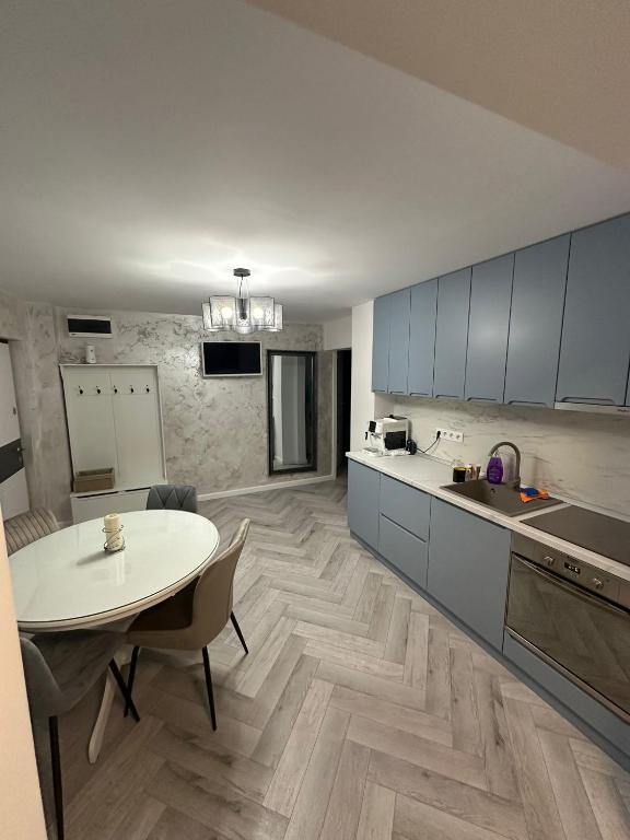 a kitchen with a table and a dining room at Davinci Apartment in Sibiu