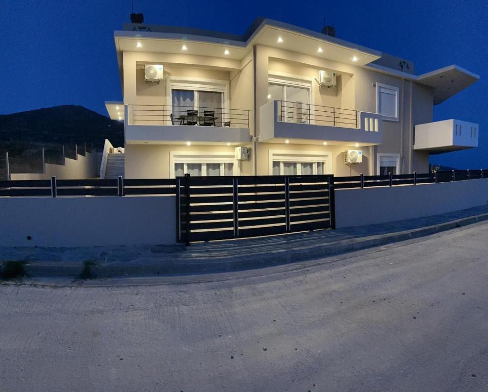a large house with a fence in front of it at Eagle View Karystos in Karistos