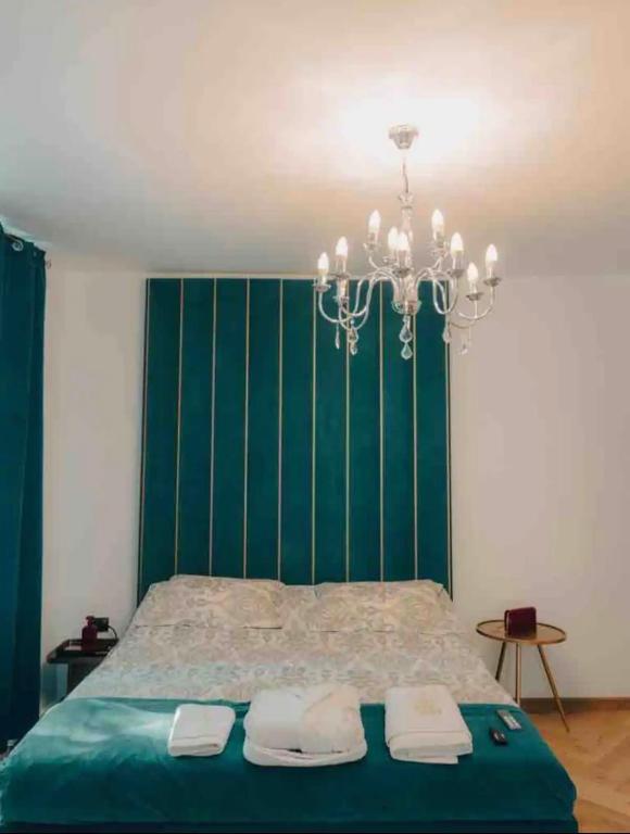 a bedroom with a bed with a green wall at Old town luxury segment in Braşov