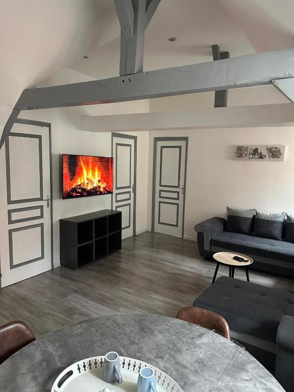 un salon avec un canapé et une cheminée dans l'établissement Mariya Appart Moment, à Saint-Omer
