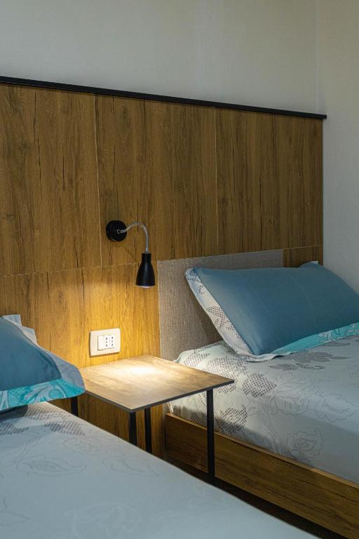 Postel nebo postele na pokoji v ubytování Hotel Olti