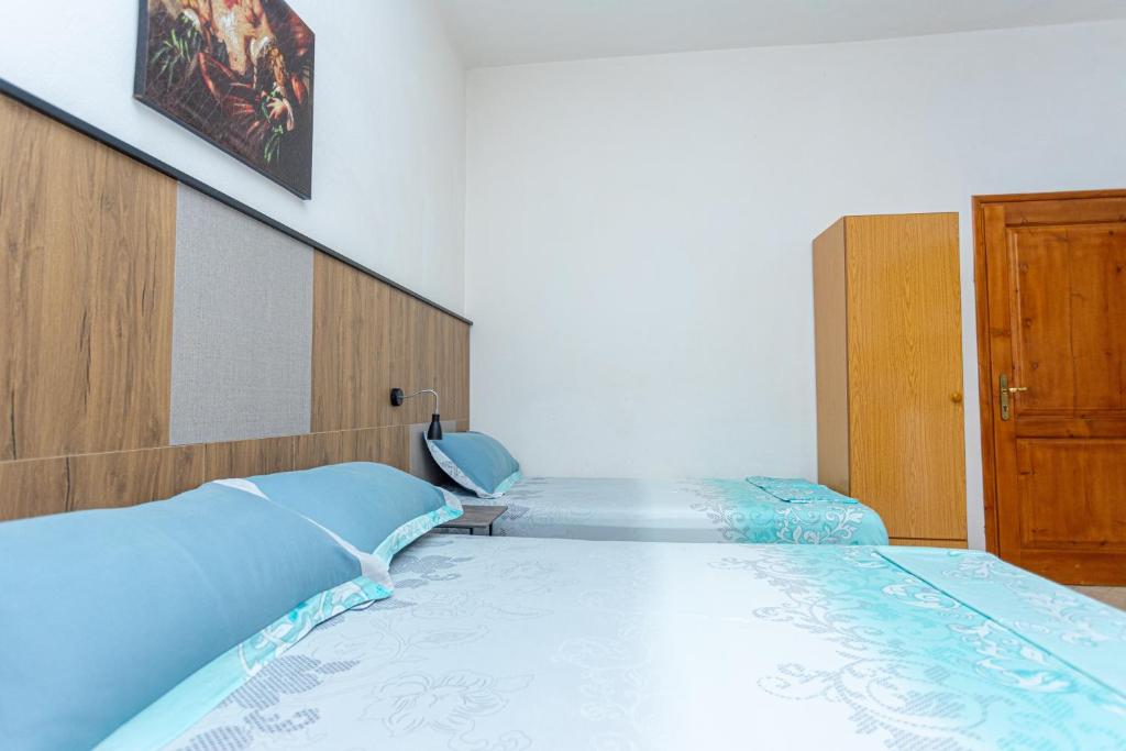 Postel nebo postele na pokoji v ubytování Hotel Olti