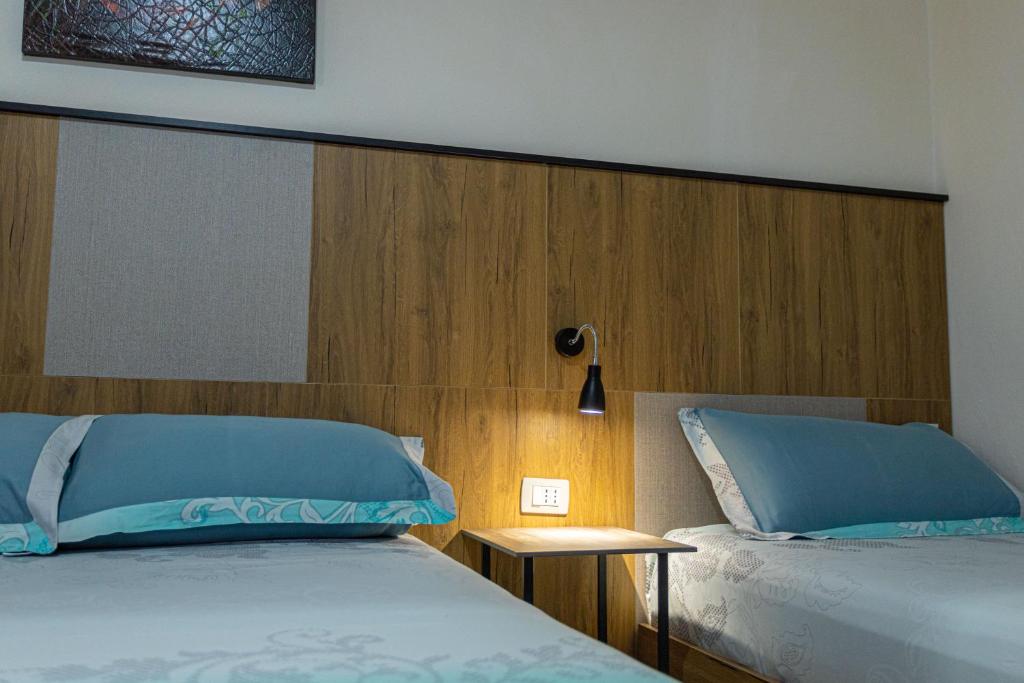 Postel nebo postele na pokoji v ubytování Hotel Olti