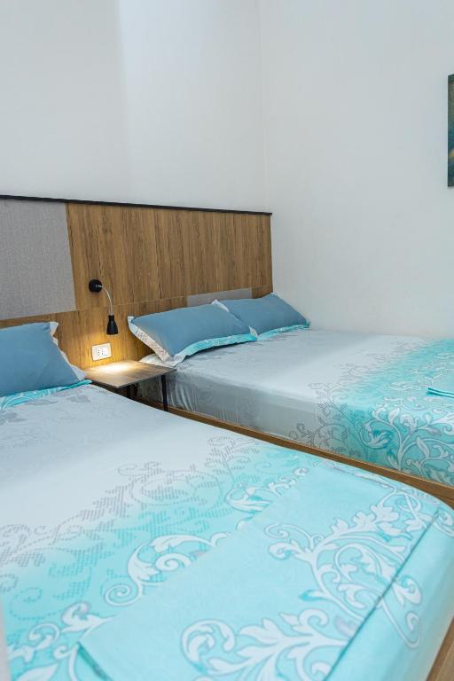 Postel nebo postele na pokoji v ubytování Hotel Olti