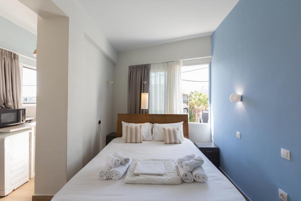 a bedroom with a bed with towels on it at Theo Apartment Rethymno in Rethymno