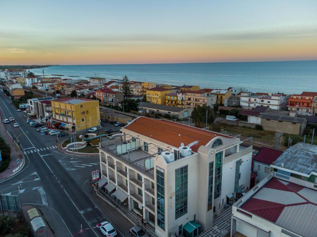 an aerial view of a city with the ocean at Hotel Napoleon in Torre Melissa