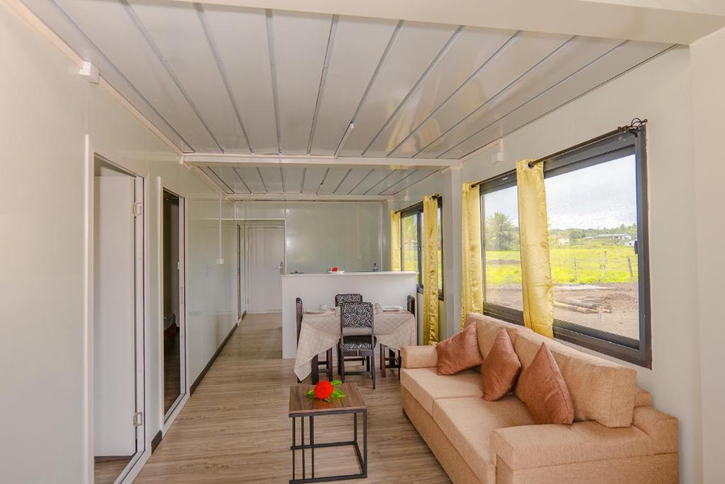 a living room with a couch and a table at Shalini Garden Hotel & Apartments in Singatoka