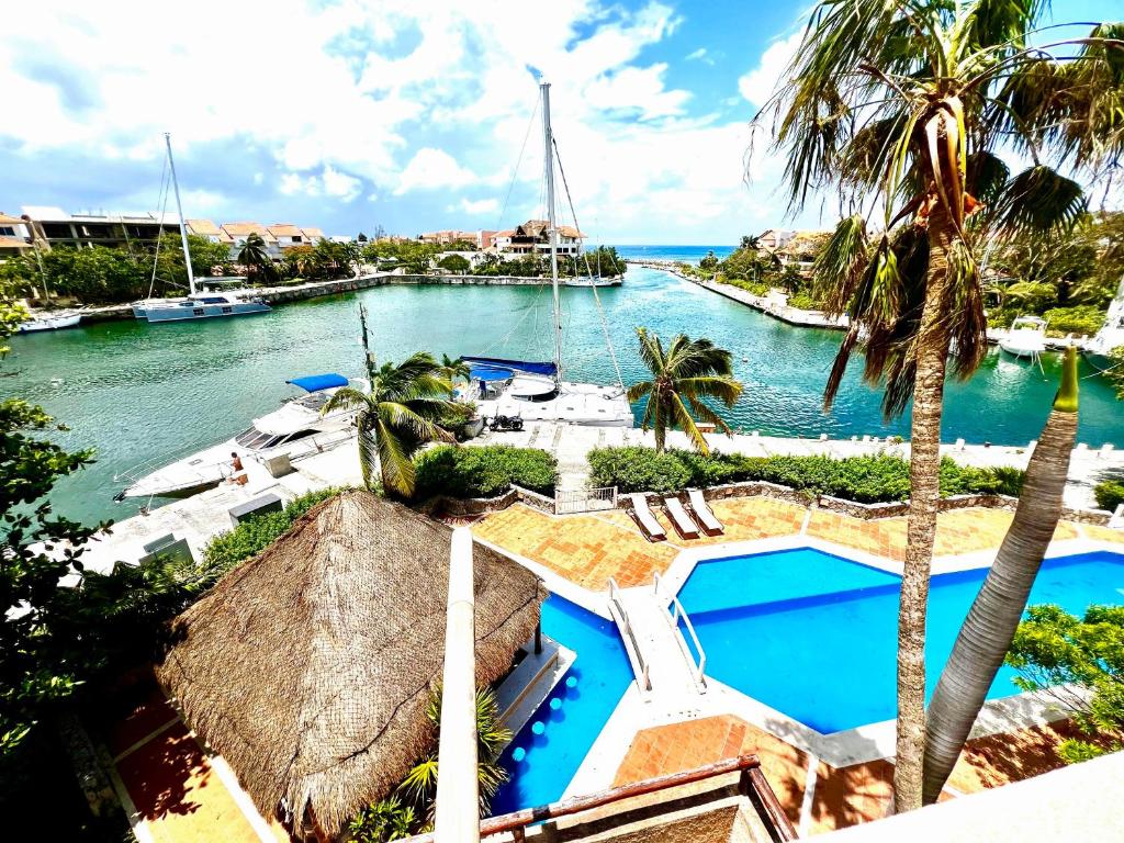 an aerial view of a resort with a boat in the water at Ocean & Marina views,Affordable,Spoil yourself! in Puerto Aventuras