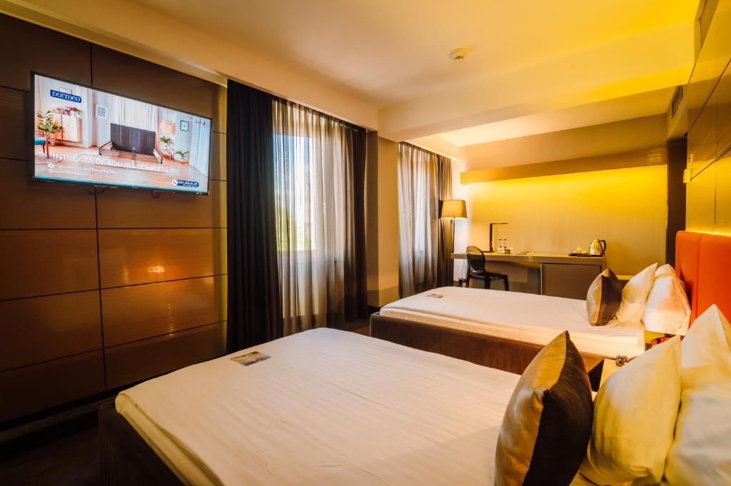 Postel nebo postele na pokoji v ubytování Plaza V Hotel