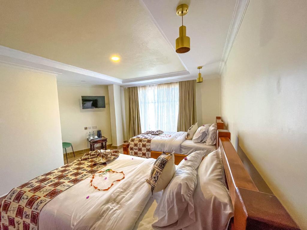 Postel nebo postele na pokoji v ubytování Pori City Hotel