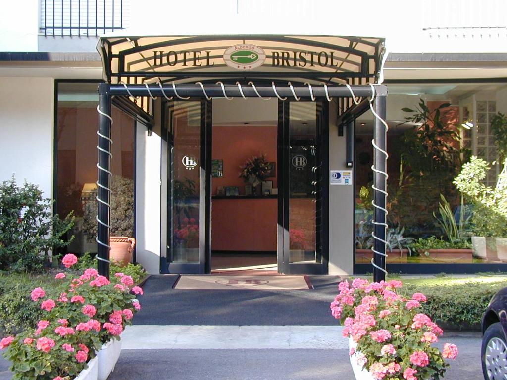 a entrance to a building with flowers in front of it at Hotel Bristol in Tirrenia