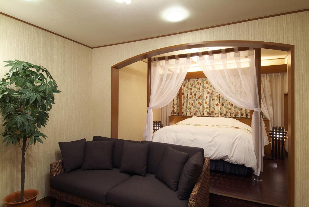 Postel nebo postele na pokoji v ubytování hotelLUANA 18歳未満入場禁止