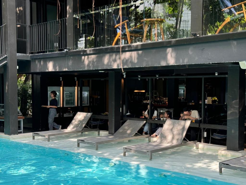 Poolside loungers sit directly in front of the hotel’s shaded ground-floor spaces.