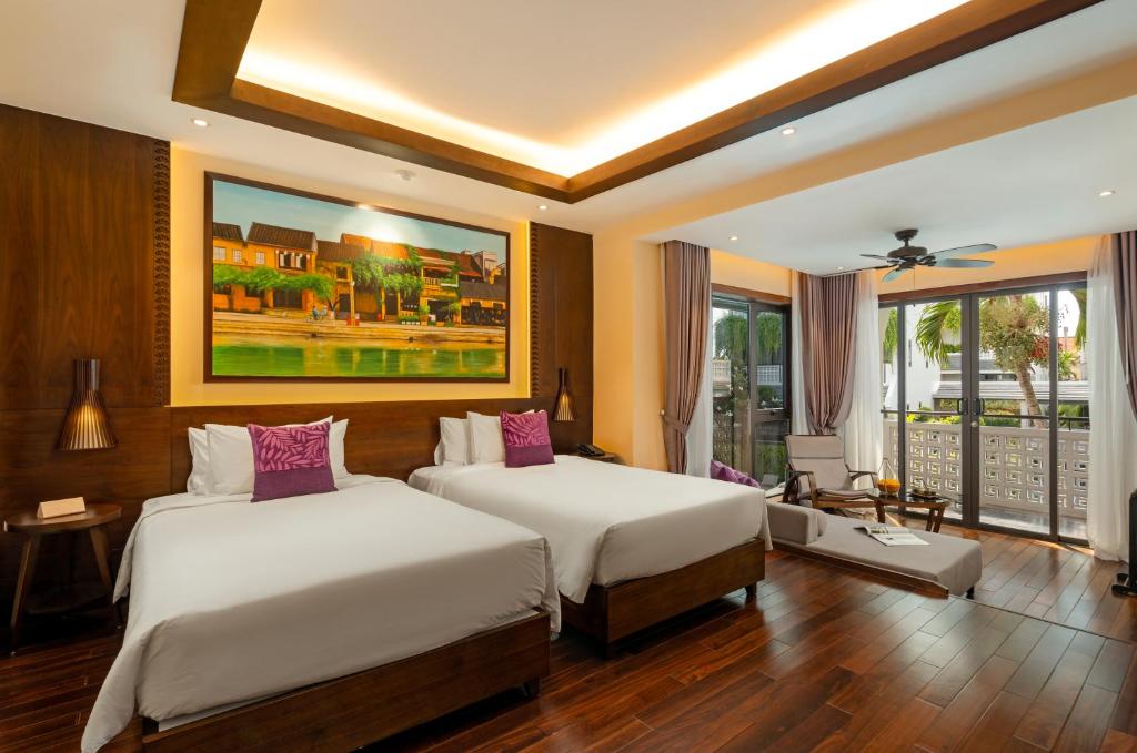 Postel nebo postele na pokoji v ubytování The Saga Hotel Hoi An