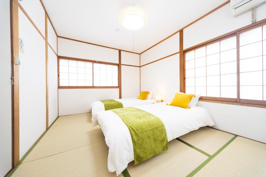 Postel nebo postele na pokoji v ubytování Miraie Yokkaichi Aobacho