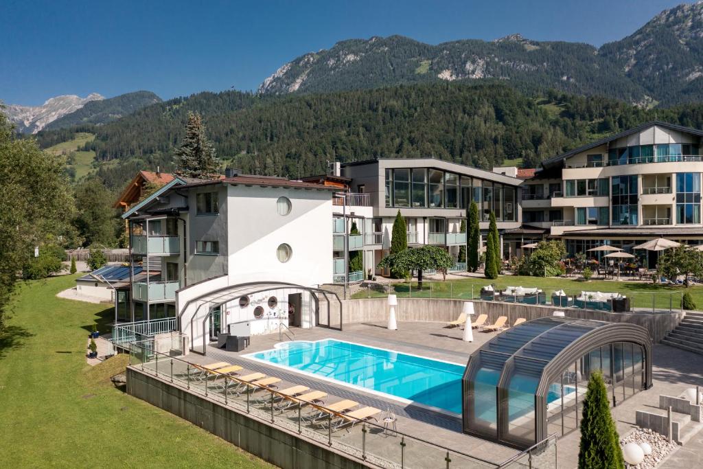 an aerial view of a resort with a swimming pool at Hartweger's Hotel in Haus im Ennstal