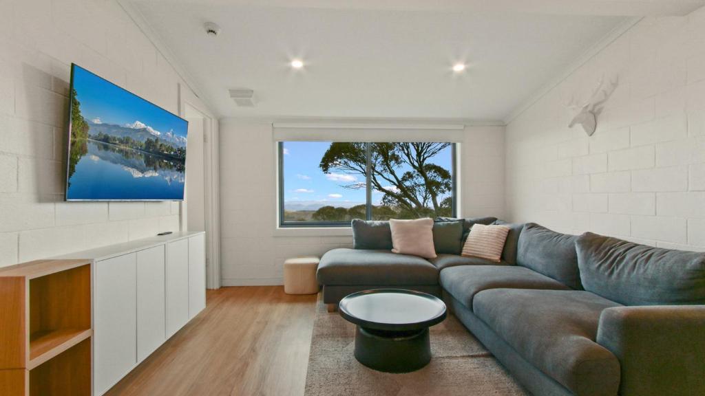 a living room with a couch and a tv at Alpine Heights 9 in Mount Hotham