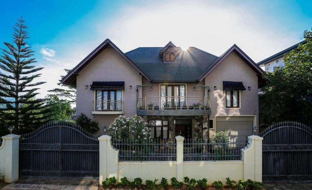 a house with a fence in front of it at The Manor Hanthana in Kandy