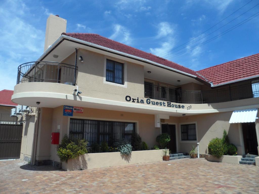 a building with a sign that reads ola great house at Oria Guest House in Cape Town