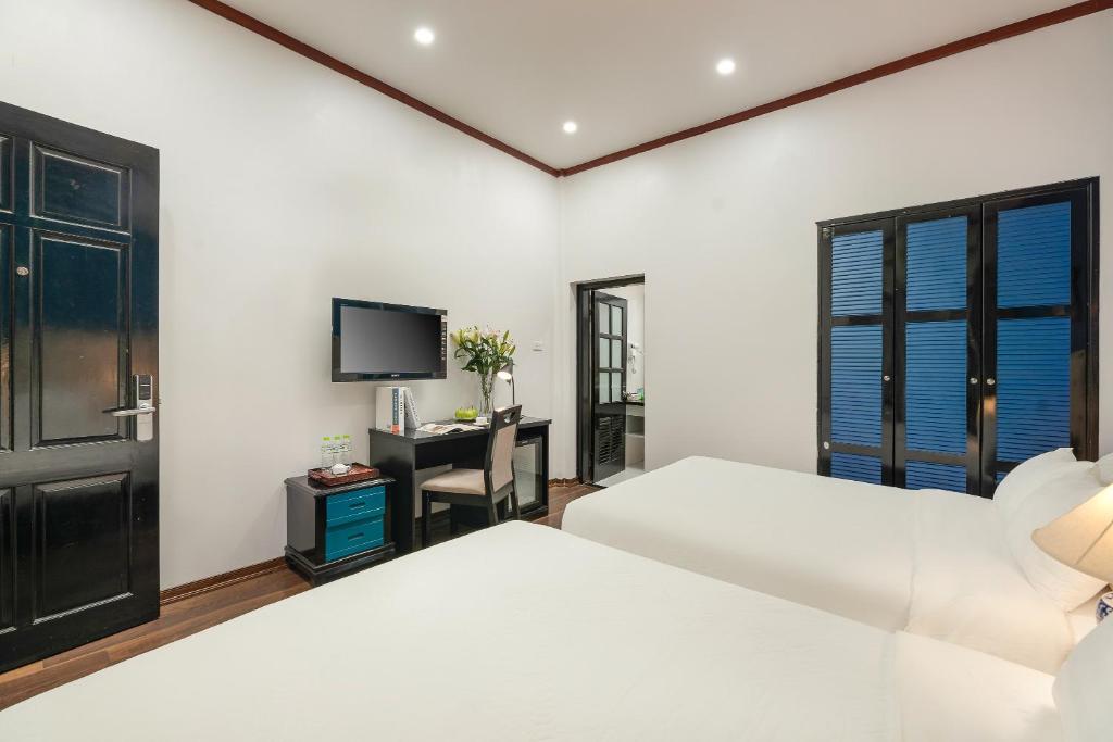 Postel nebo postele na pokoji v ubytování Hanoi Starlight Boutique Hotel