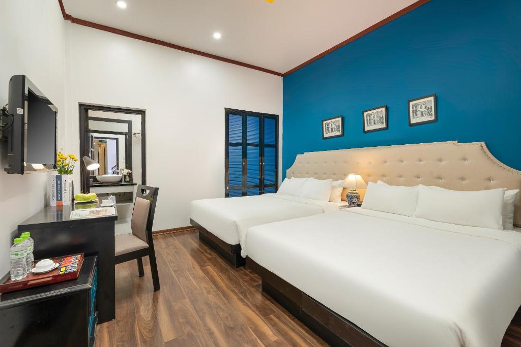 Postel nebo postele na pokoji v ubytování Hanoi Starlight Boutique Hotel