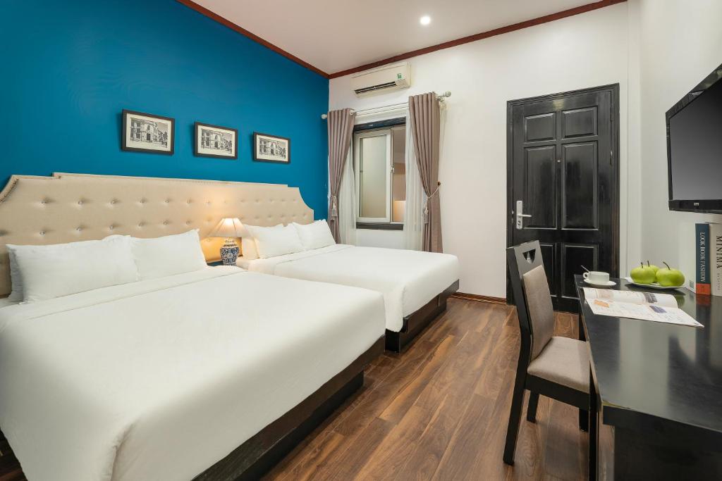 Postel nebo postele na pokoji v ubytování Hanoi Starlight Boutique Hotel