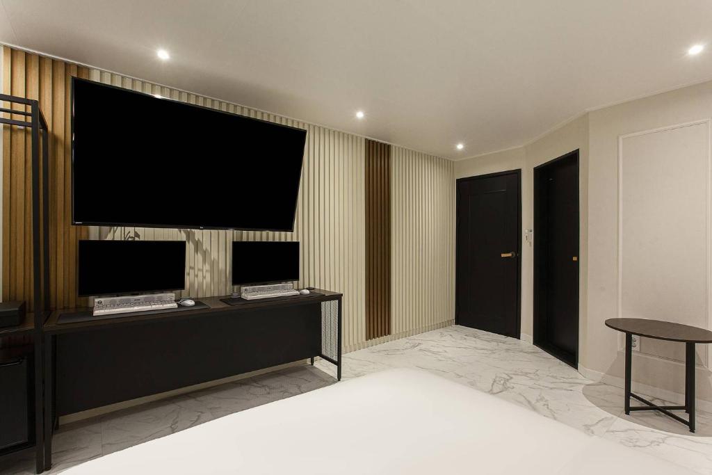Postel nebo postele na pokoji v ubytování Grazie Hotel Tanhyeon