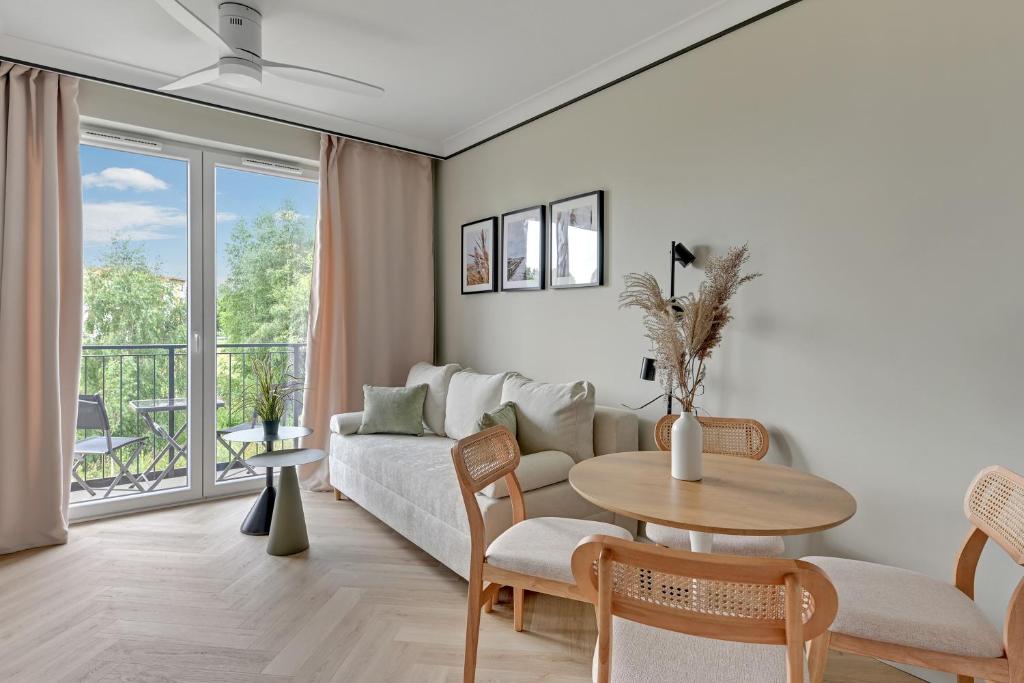 a living room with a couch and a table at GRANO FLATS Trimare Sztutowo in Sztutowo