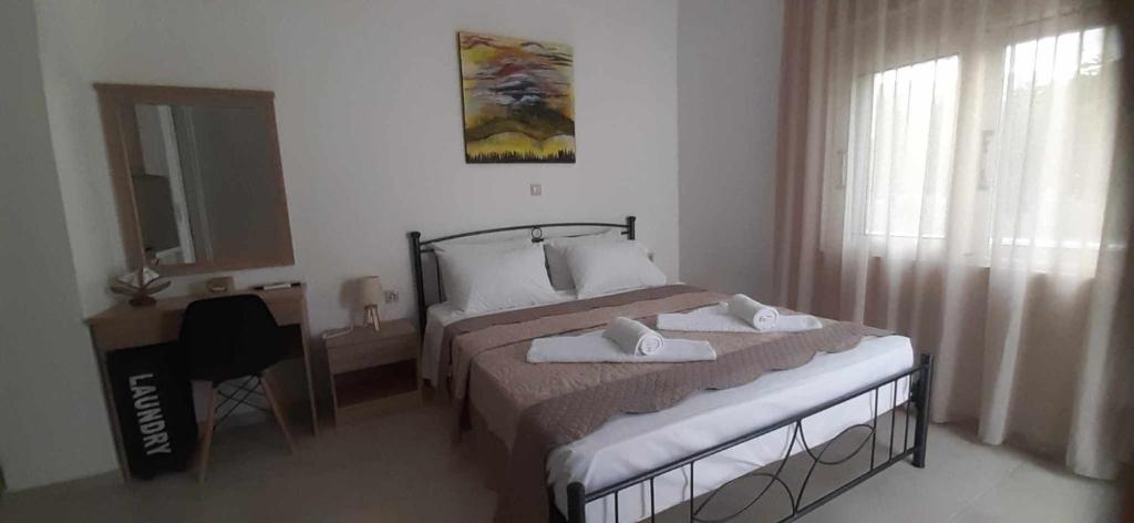 a bedroom with a bed with towels on it at Lady S Holiday Studio in Lampi