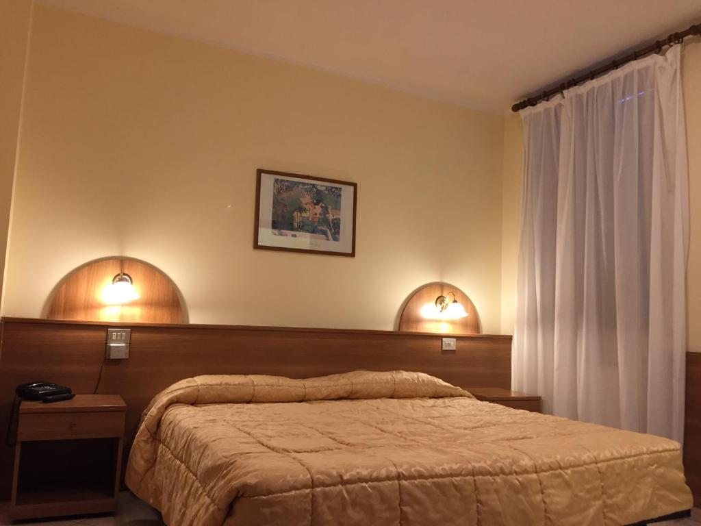 Postel nebo postele na pokoji v ubytování Hotel Rocco