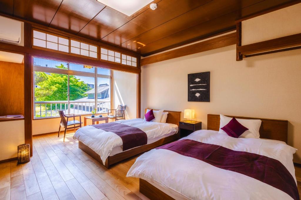 Postel nebo postele na pokoji v ubytování Ryokan Marumo
