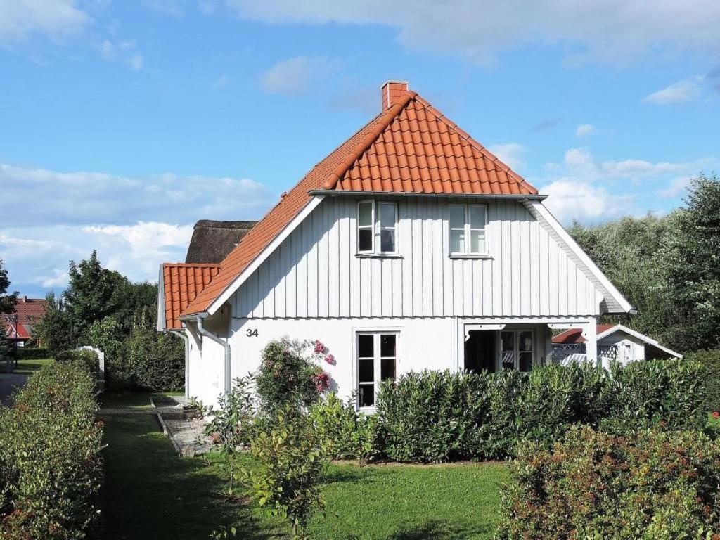 a white house with an orange roof at Strandkörbchen in Groß Schwansee