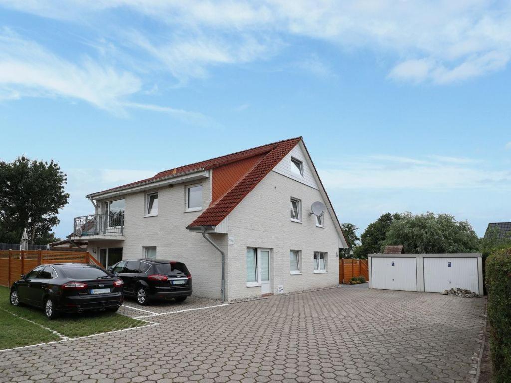 a house with two cars parked in a driveway at Teresa Fewo in Boltenhagen