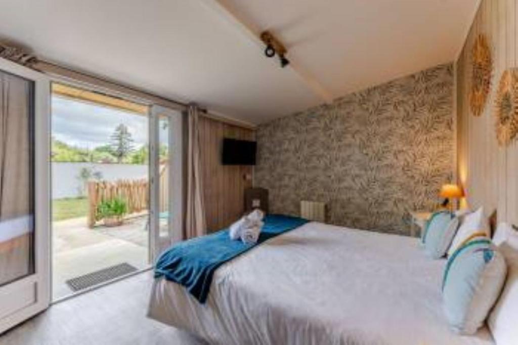 Postel nebo postele na pokoji v ubytování Hôtel Le Grain de Sable