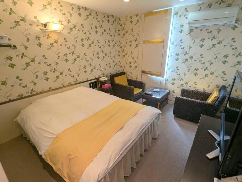 Postel nebo postele na pokoji v ubytování HOTEL Mythos (ホテル ミュートス)