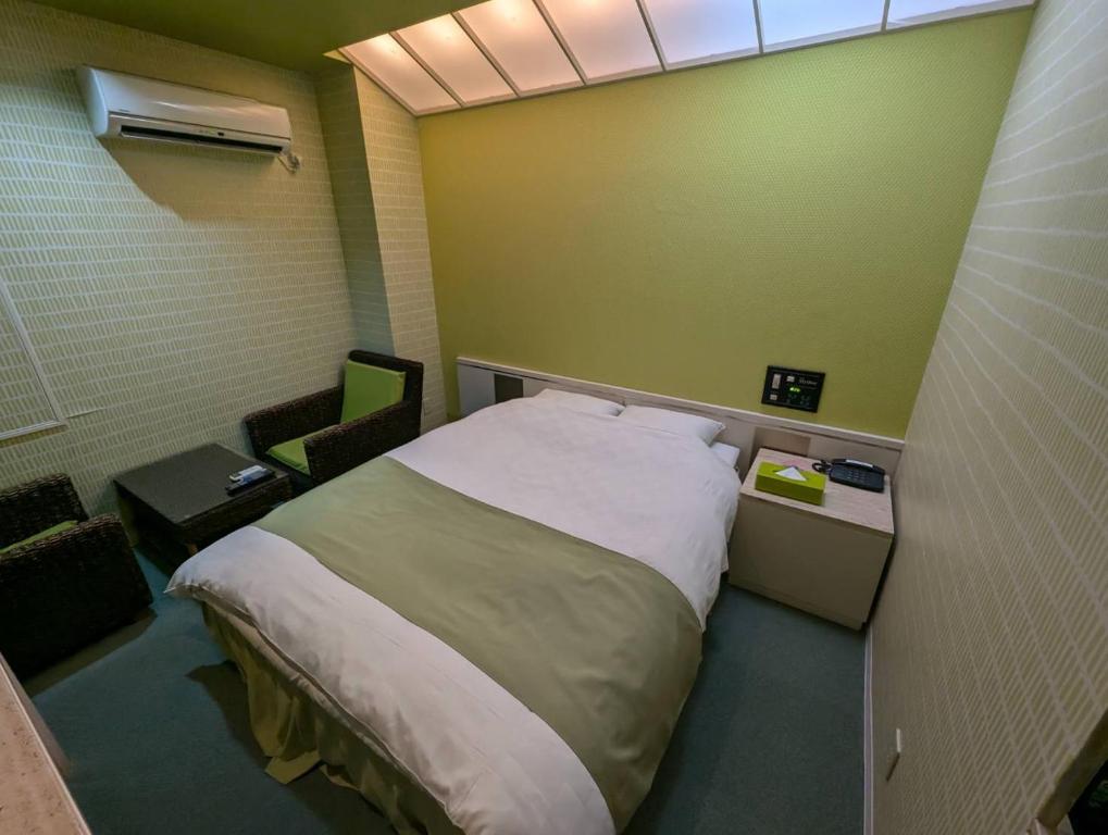 Postel nebo postele na pokoji v ubytování HOTEL Mythos (ホテル ミュートス)