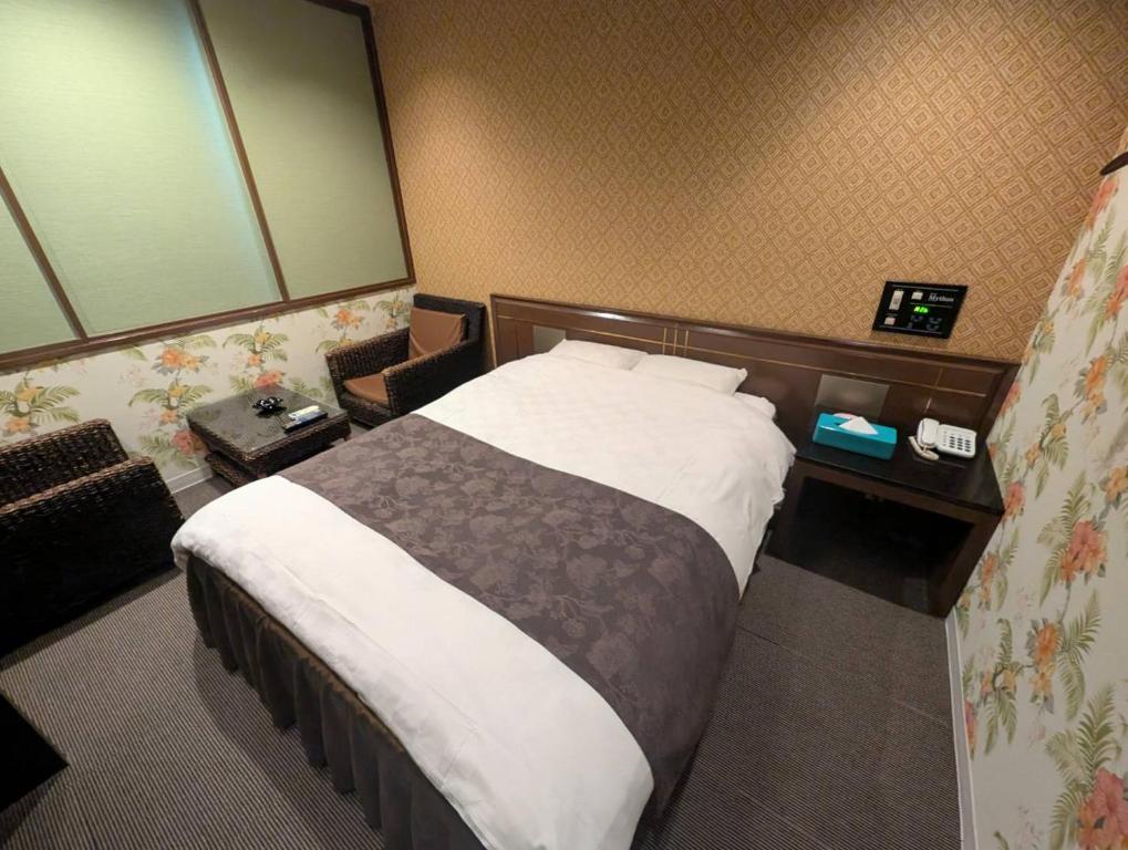 Postel nebo postele na pokoji v ubytování HOTEL Mythos (ホテル ミュートス)