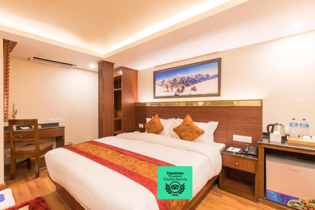 a hotel room with a large bed and a desk at Thamel Boutique Hotel in Kathmandu