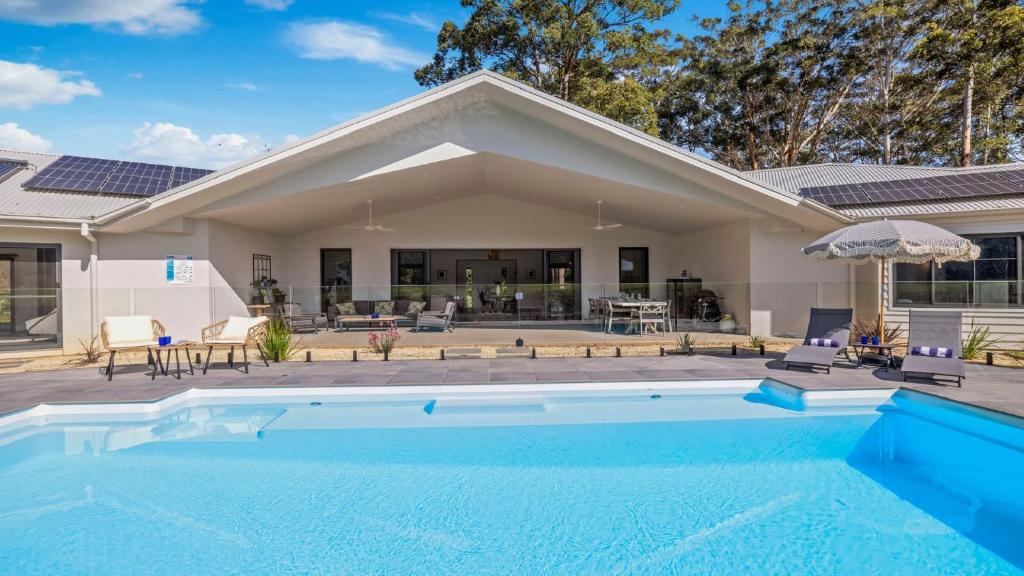 a swimming pool in front of a house at Koala Lane - Family, Pool, Sleeps 10, Luxe in Bonville