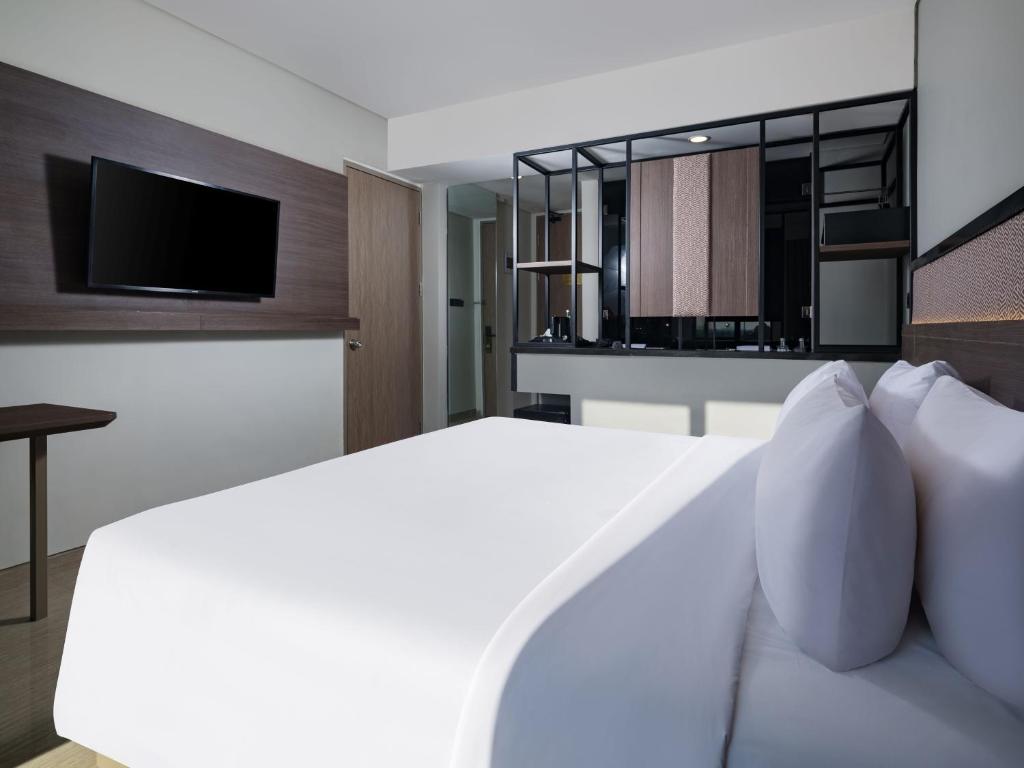 Postel nebo postele na pokoji v ubytování Hotel Santika Blitar