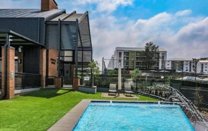 a large swimming pool in front of a building at Sweet Snuggle Sanctuary in Boksburg