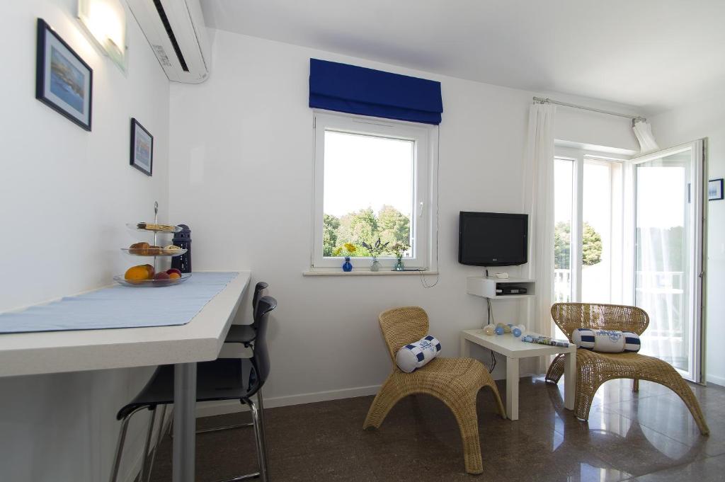 Télévision ou salle de divertissement dans l'établissement Apartments Villa Olea