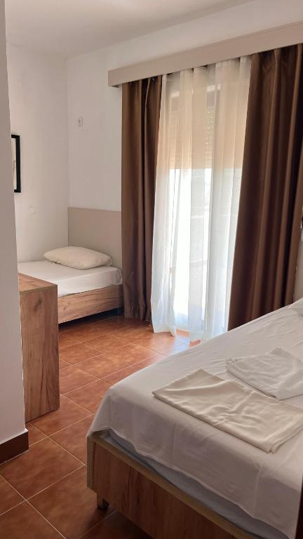 Postel nebo postele na pokoji v ubytování Buzuku House